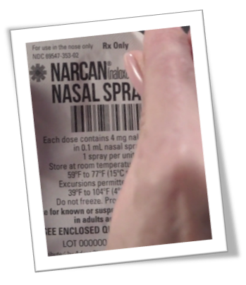 Close-up of a Narcan nasal spray label with text indicating it's for use in the nose, Rx Only, and details about dosage and storage.